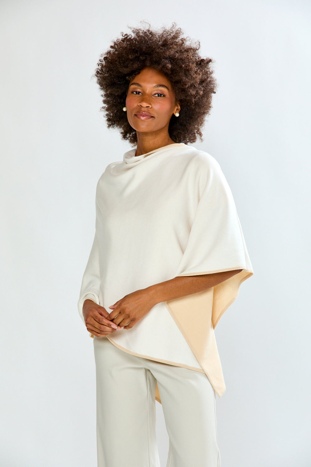 Woman wearing a two-tone top with a plain background