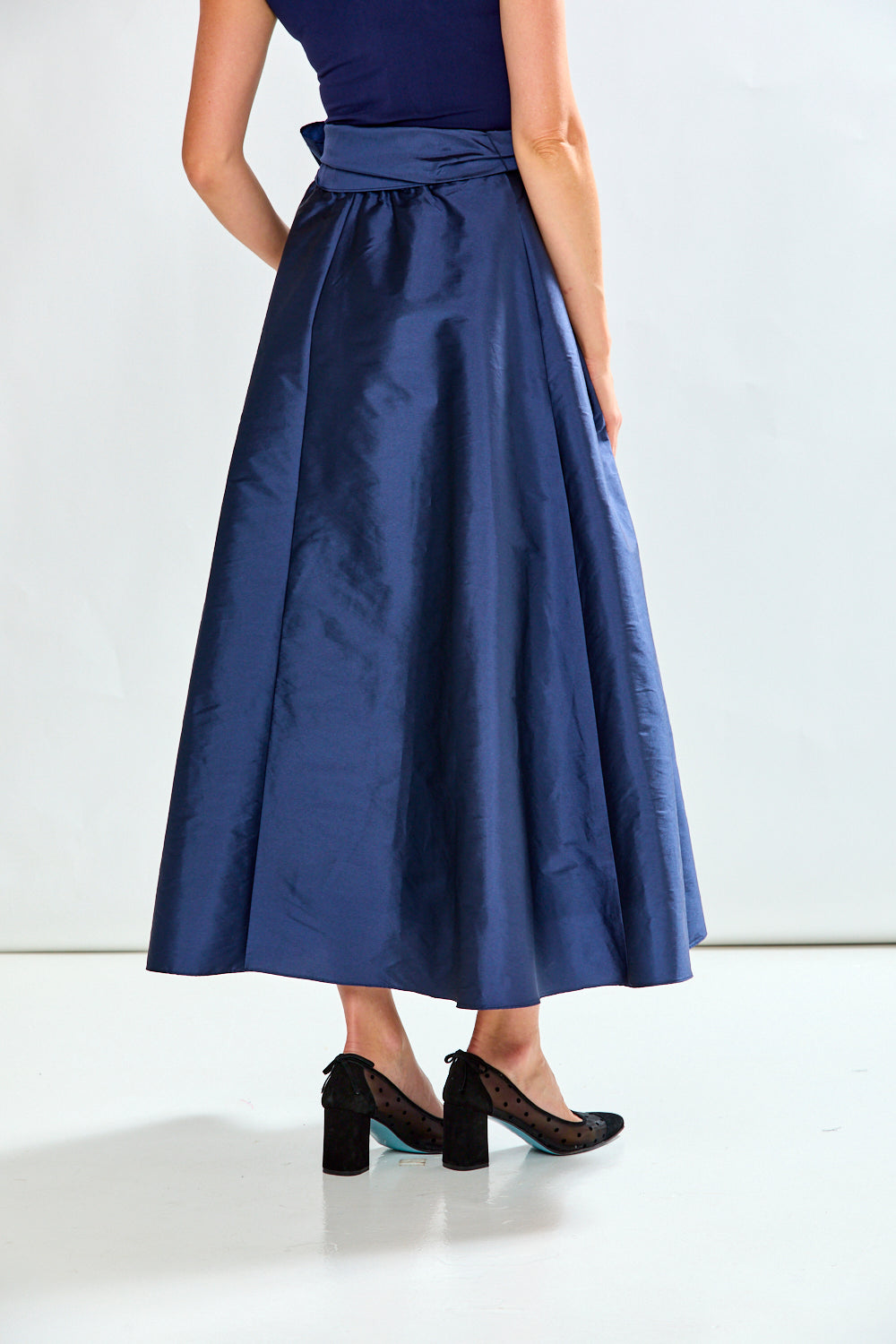 Woman wearing navy taffeta skirt