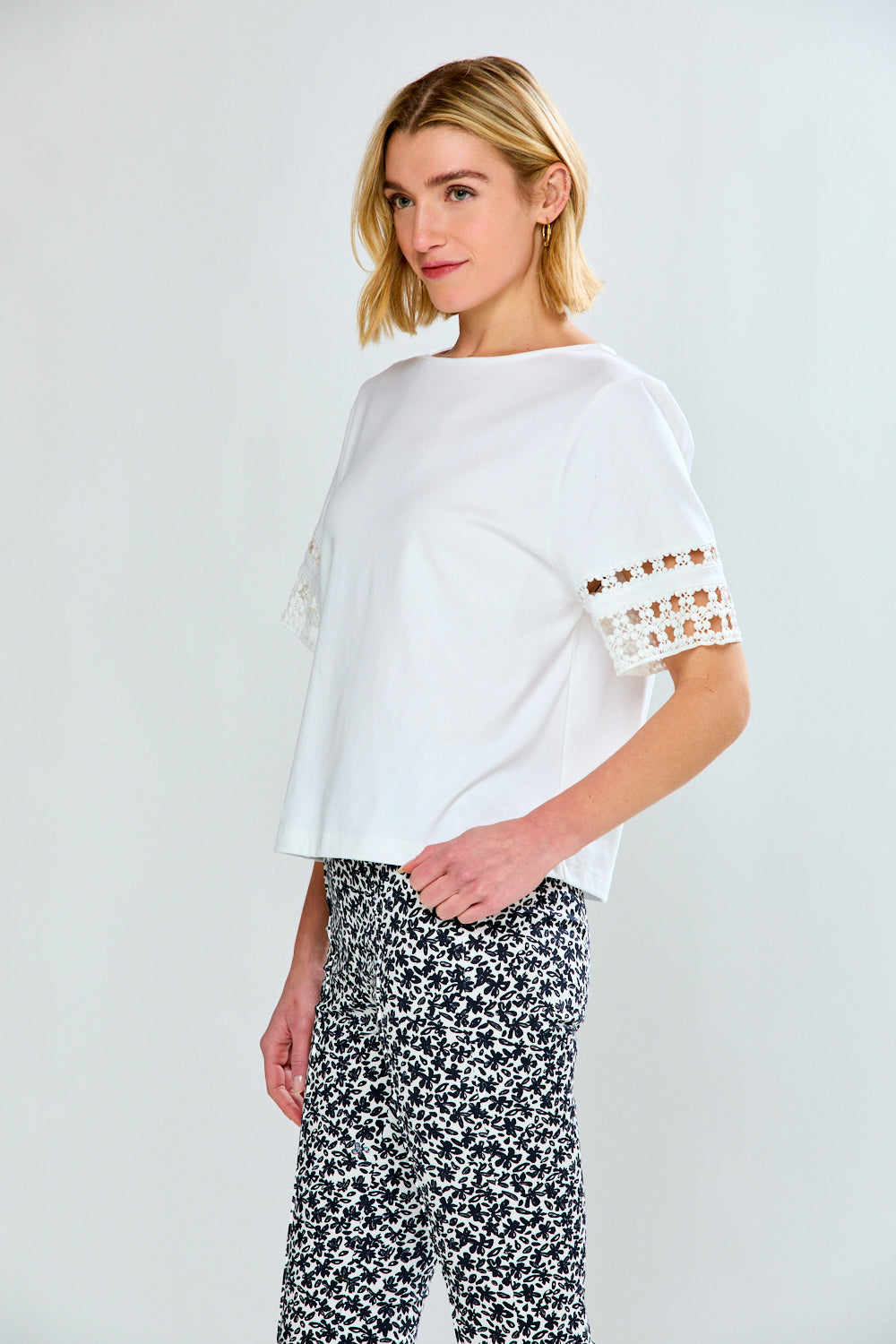 Woman in white top and printed pants