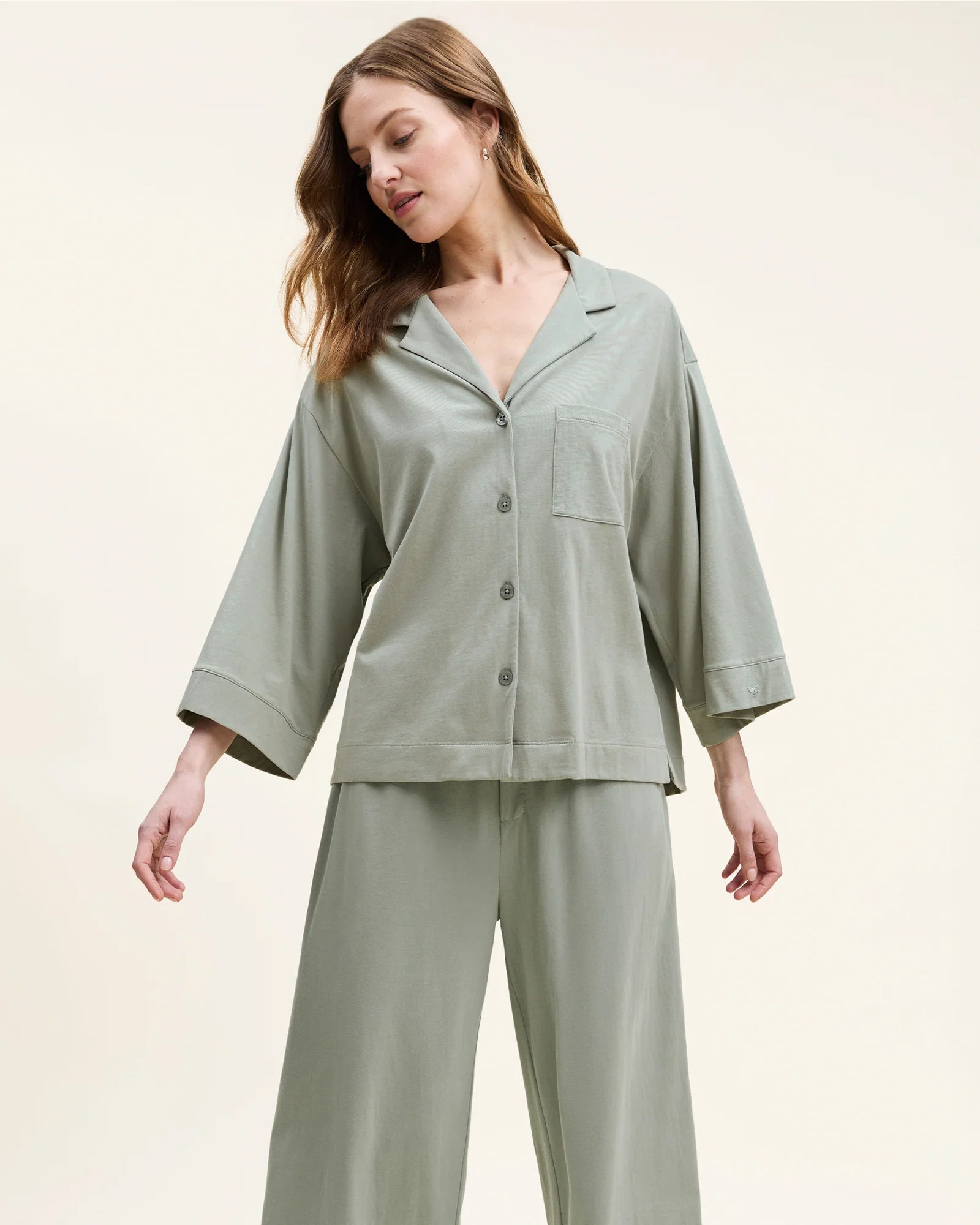 Woman in sage green pajamas