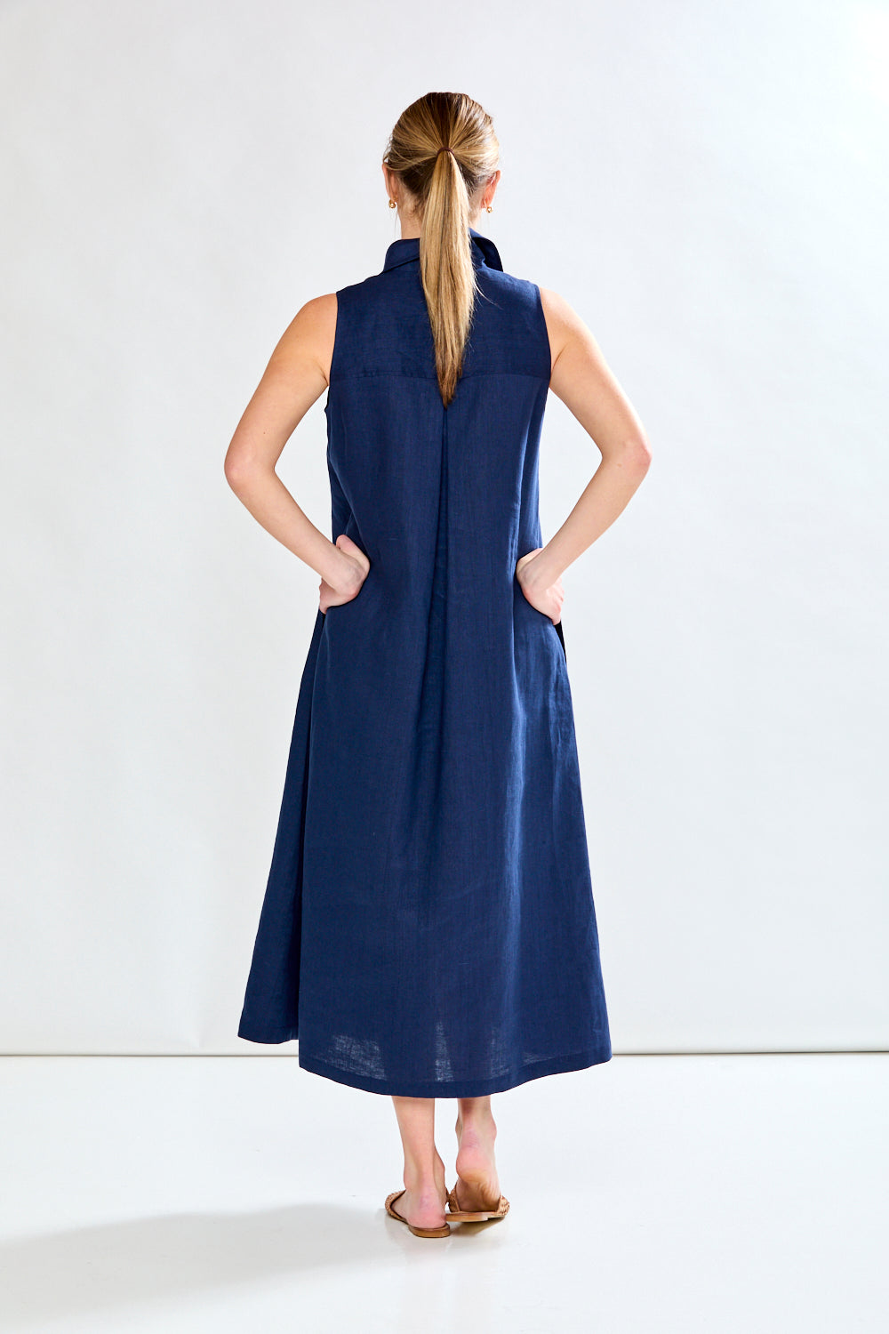 Woman in navy sleeveless dress
