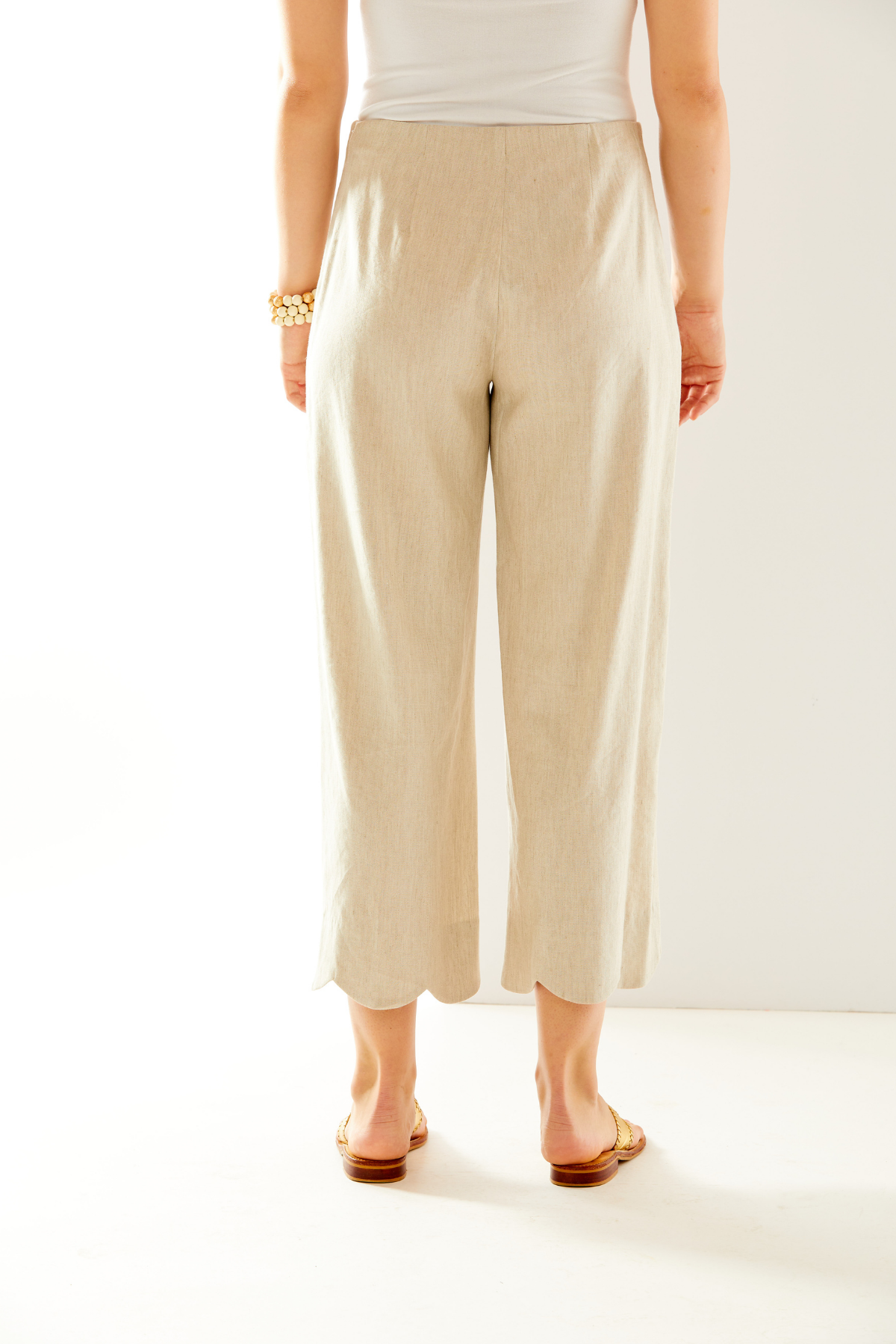 Woman in oatmeal pant with scallop hem