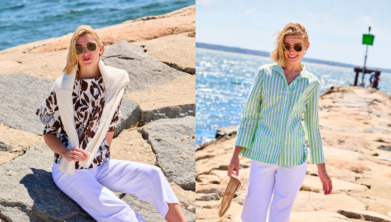 One girl sitting on a rock on the beach and one walking on the beach