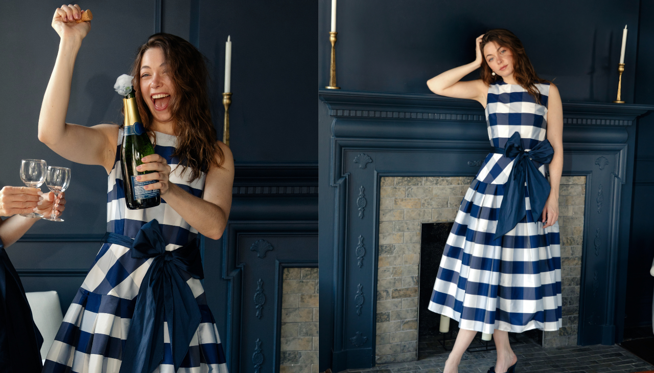 woman popping champagne and wearing The Giselle Dress in Tea Length