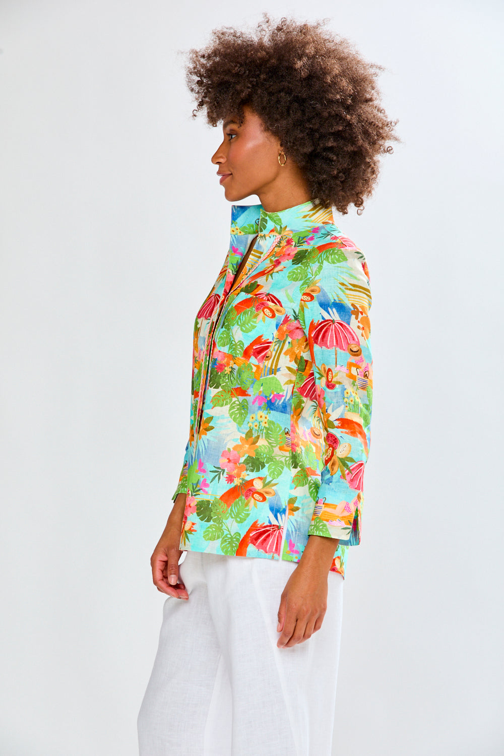 woman in tropical shirt and white pants