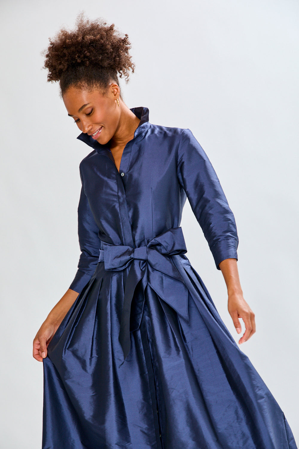 Woman in navy long taffeta dress