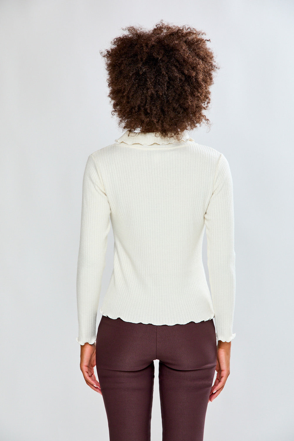 Woman in ivory top and dark pants