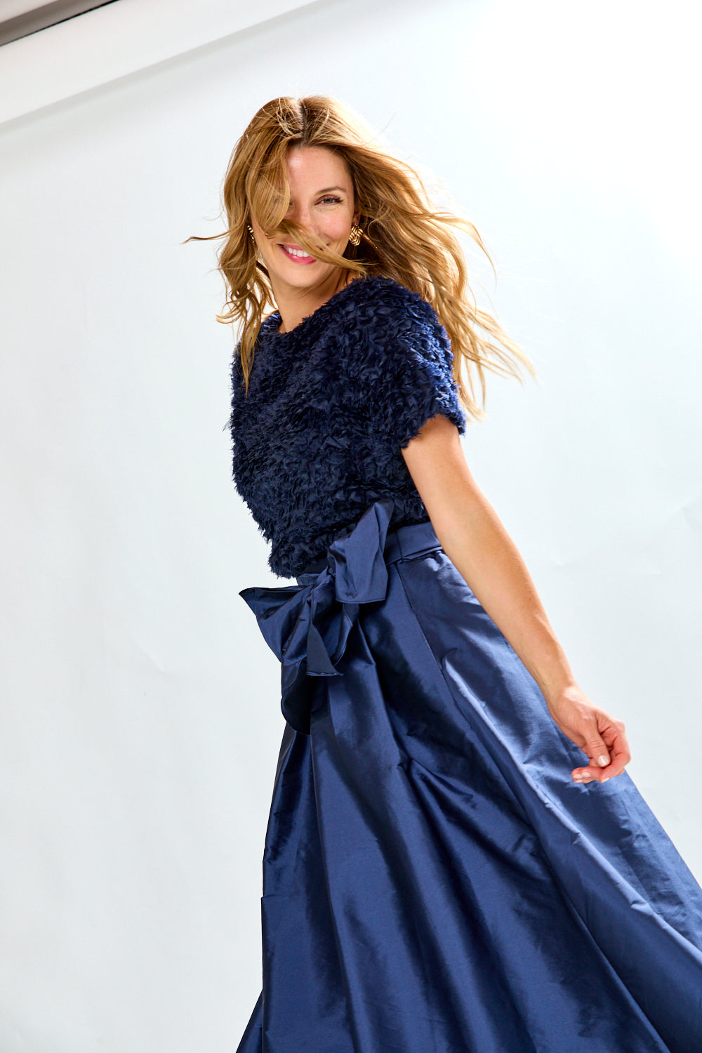 Woman wearing navy taffeta skirt