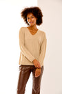 Woman in sand heather v neck sweater