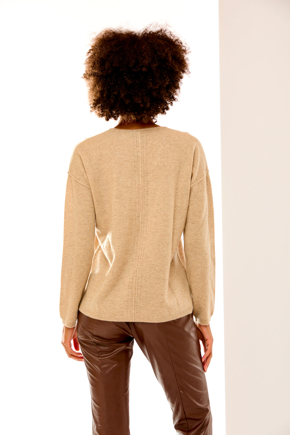 Woman in sand heather v neck sweater