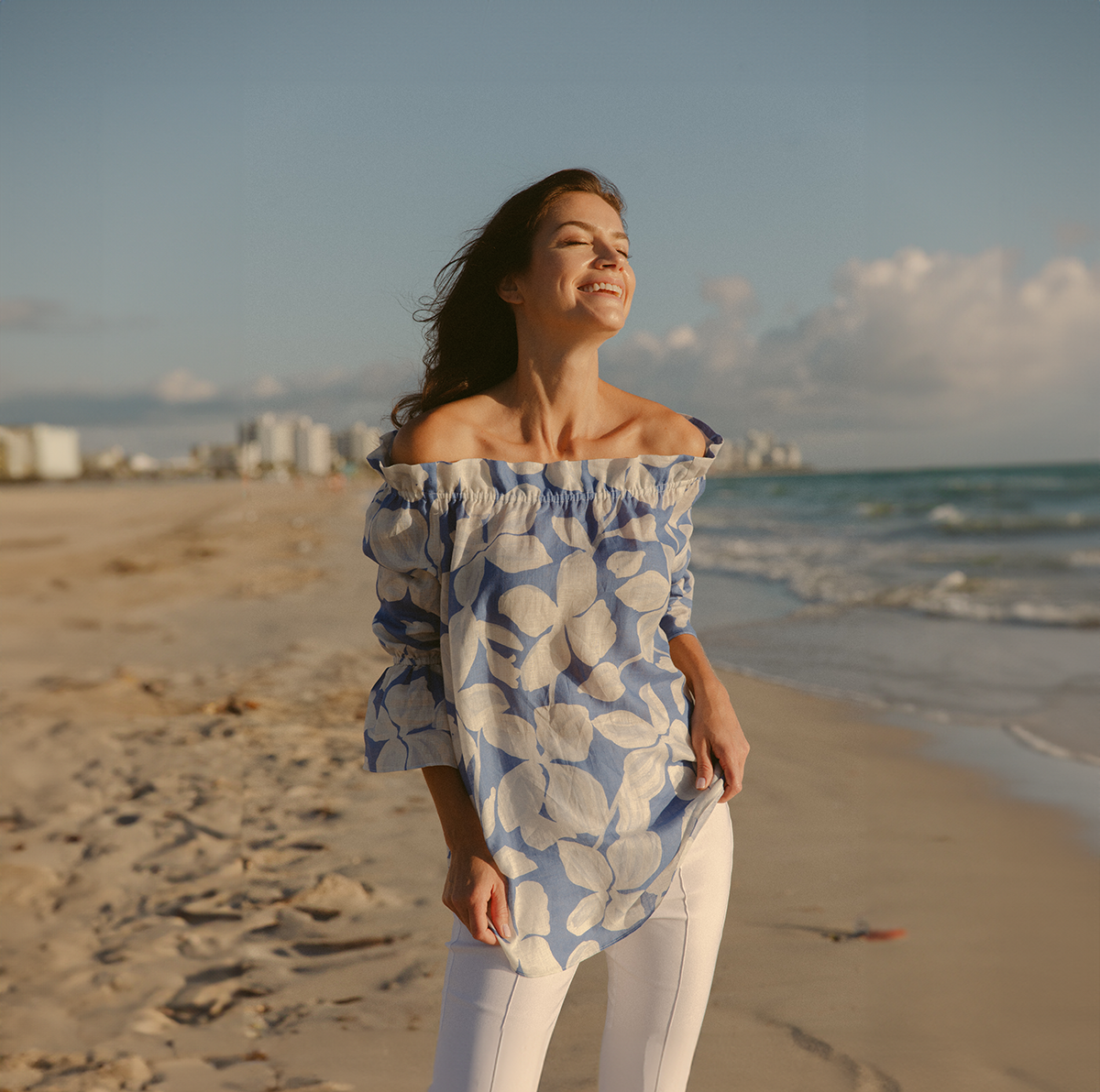 Woman wearing blue floral top on the beach