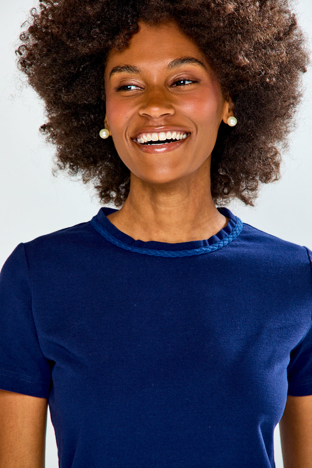 Woman wearing a blue shirt against a white background