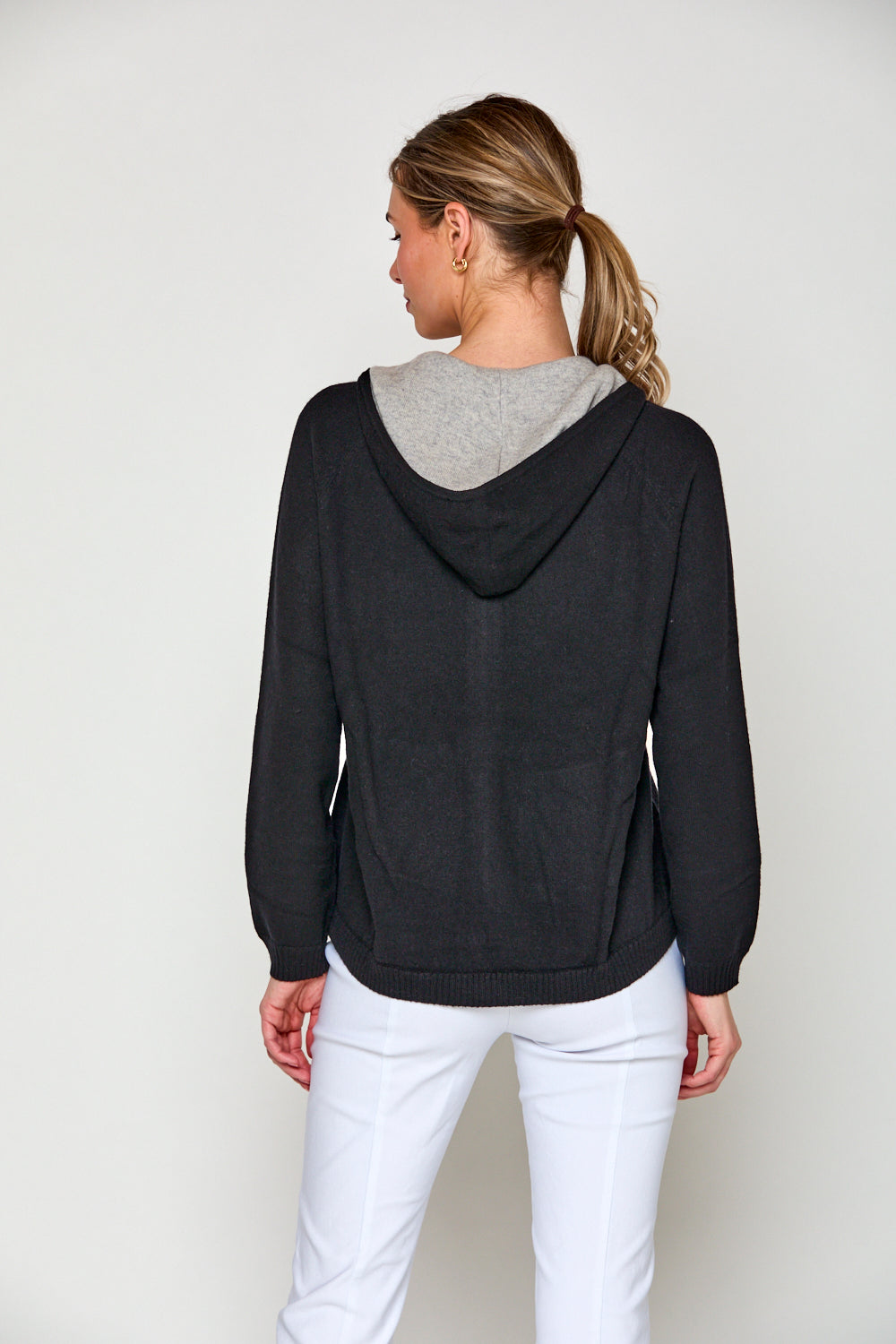 Woman in black cashmere hoodie