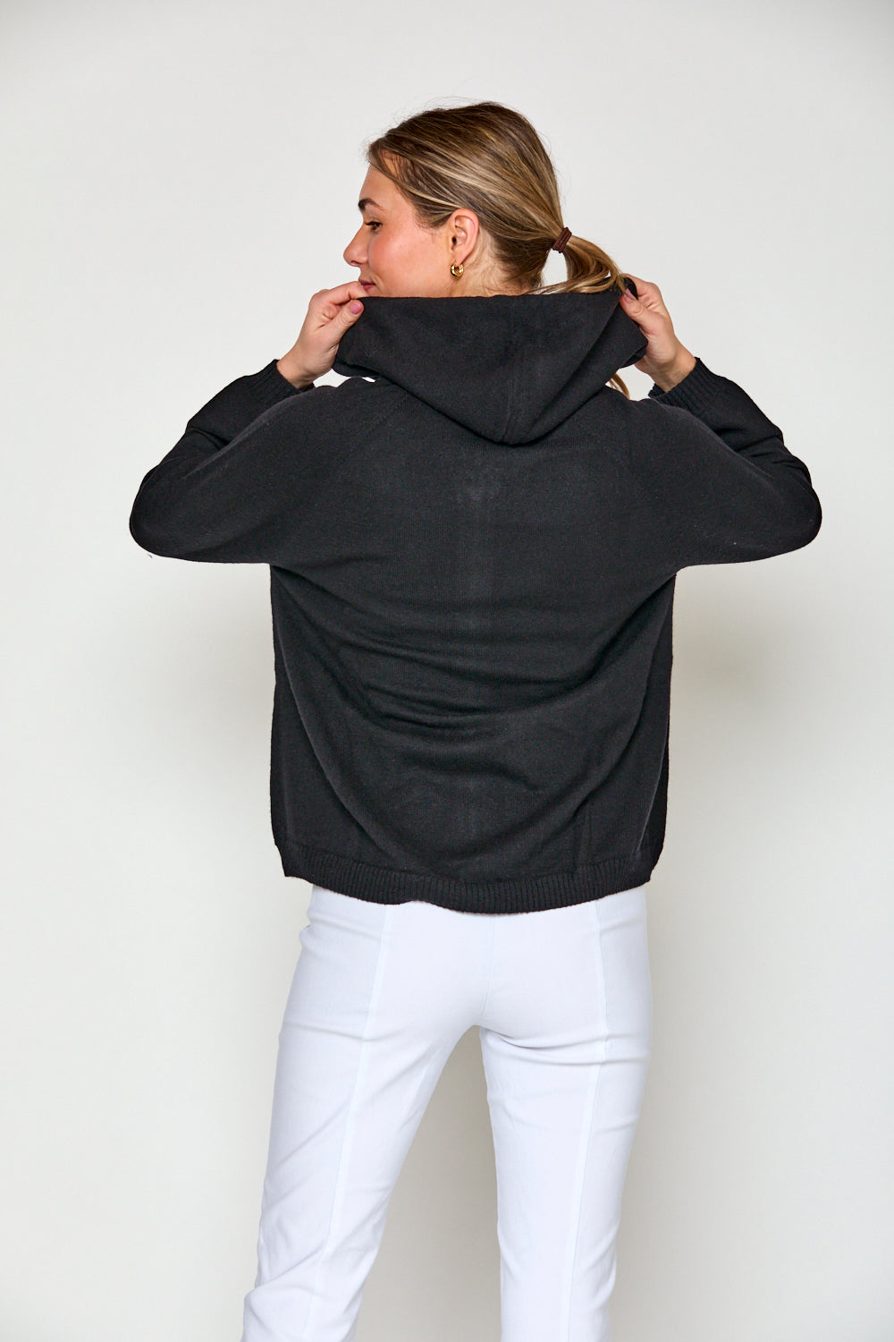 Woman in black cashmere hoodie