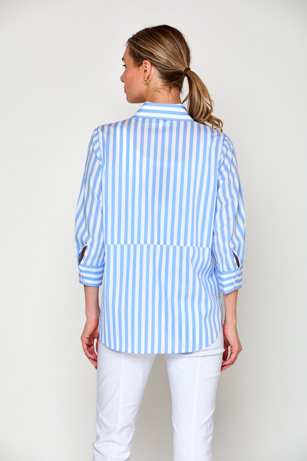 Woman in blue and white stripe blouse