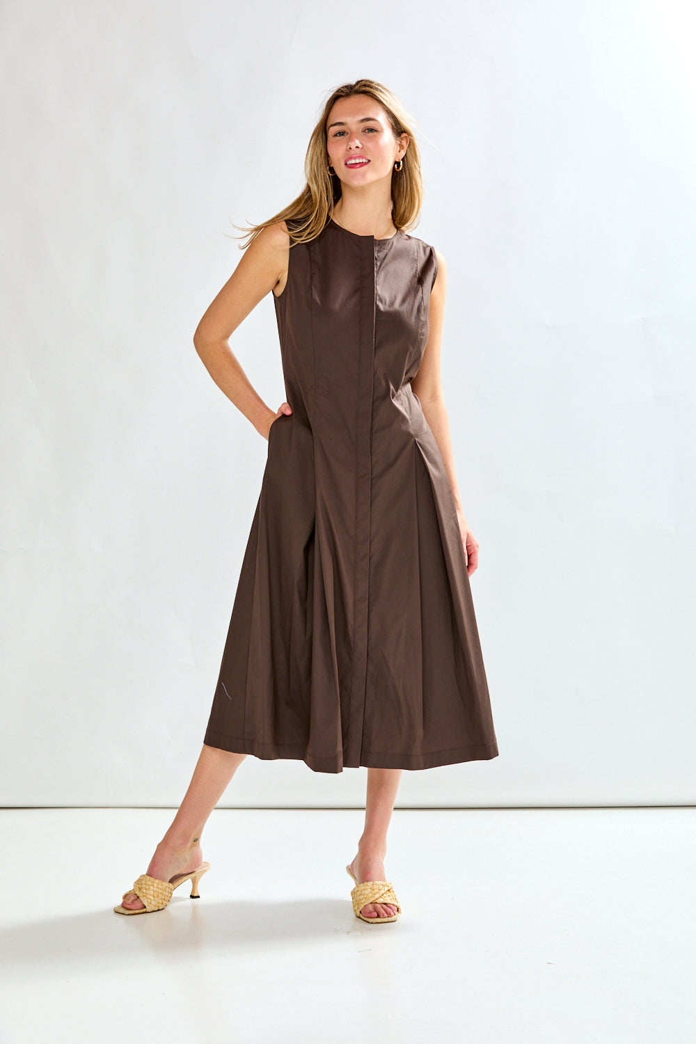 Woman wearing a brown dress against a white background
