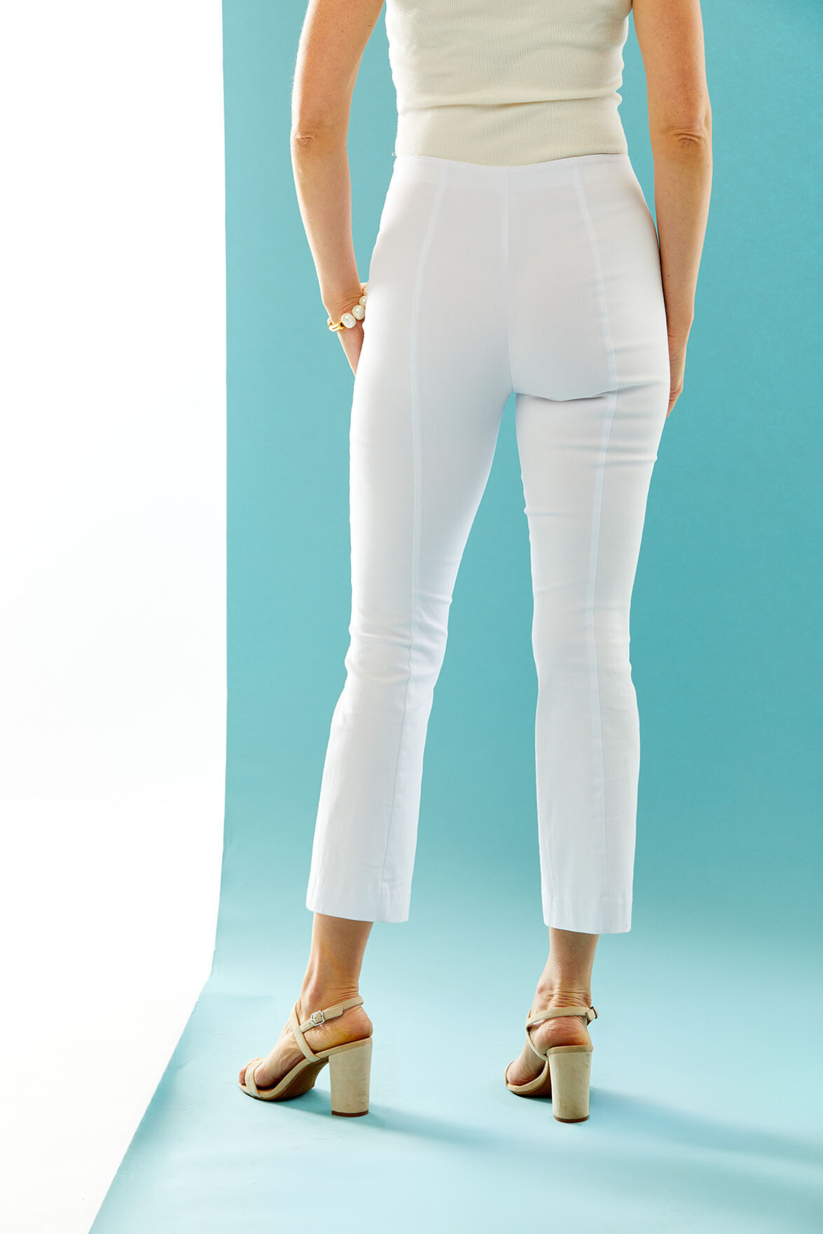 Woman in white bootcut pant