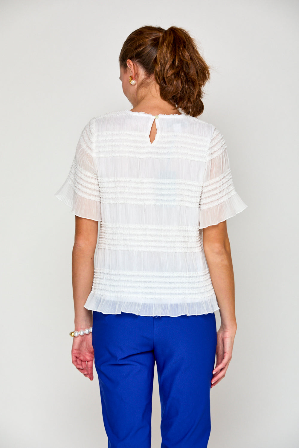 Woman in ivory short sleeve top