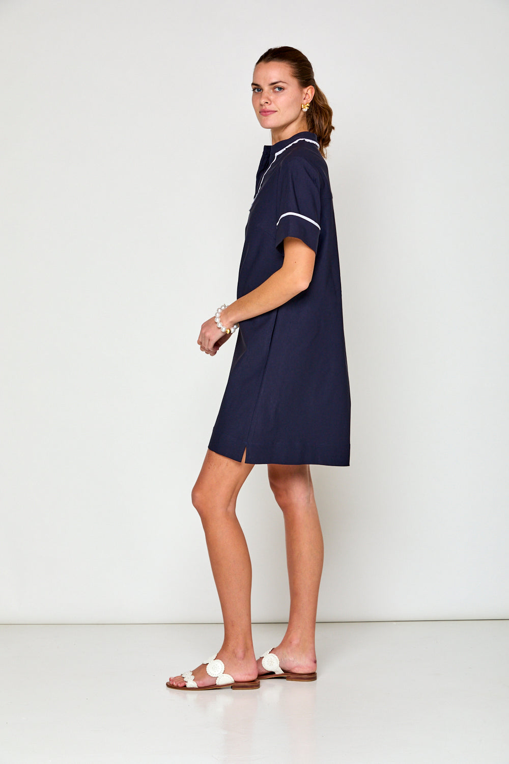 Woman in navy short sleeve dress