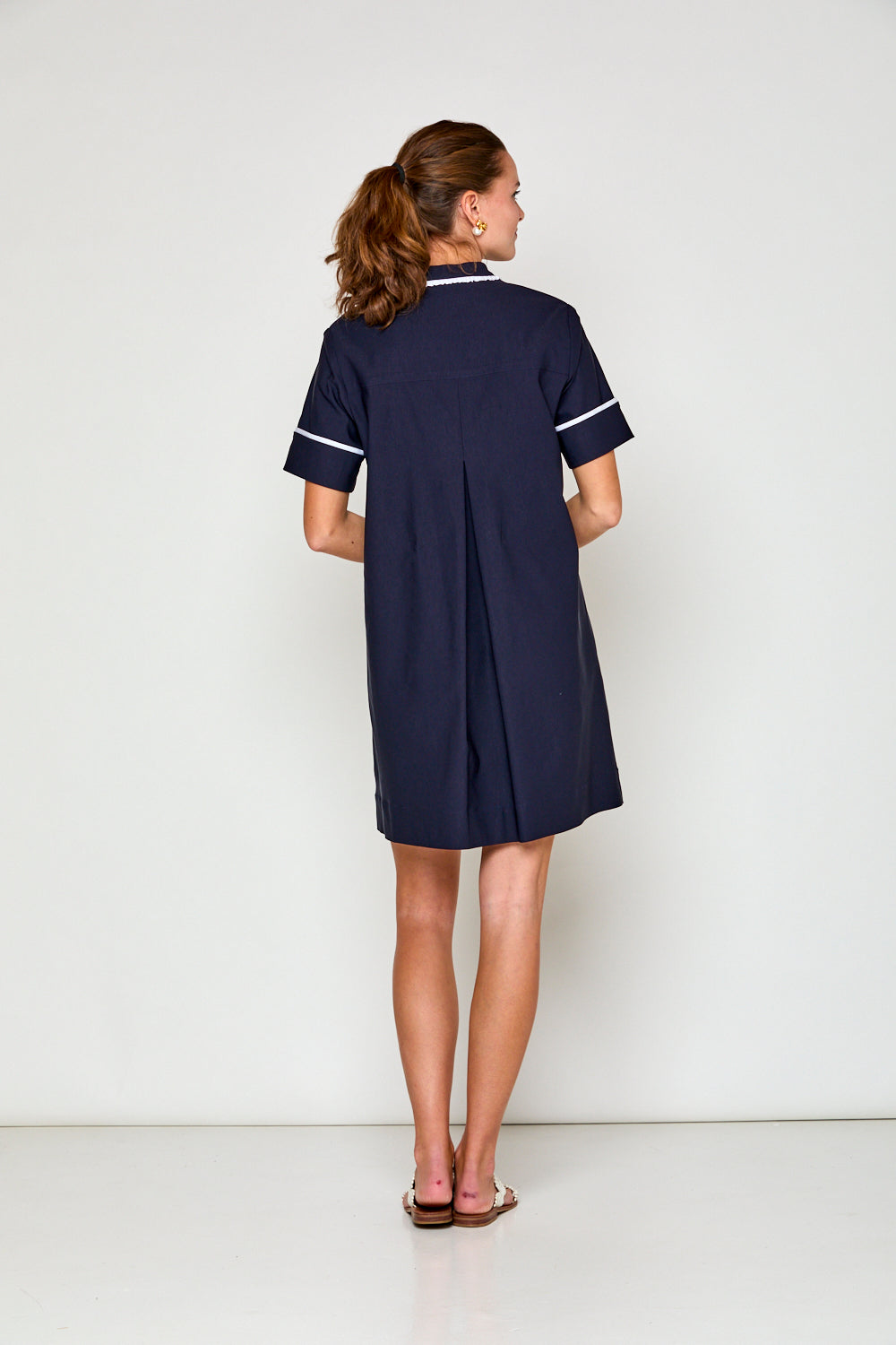 Woman in navy short sleeve dress