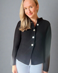 Woman in black button front nock neck cardigan