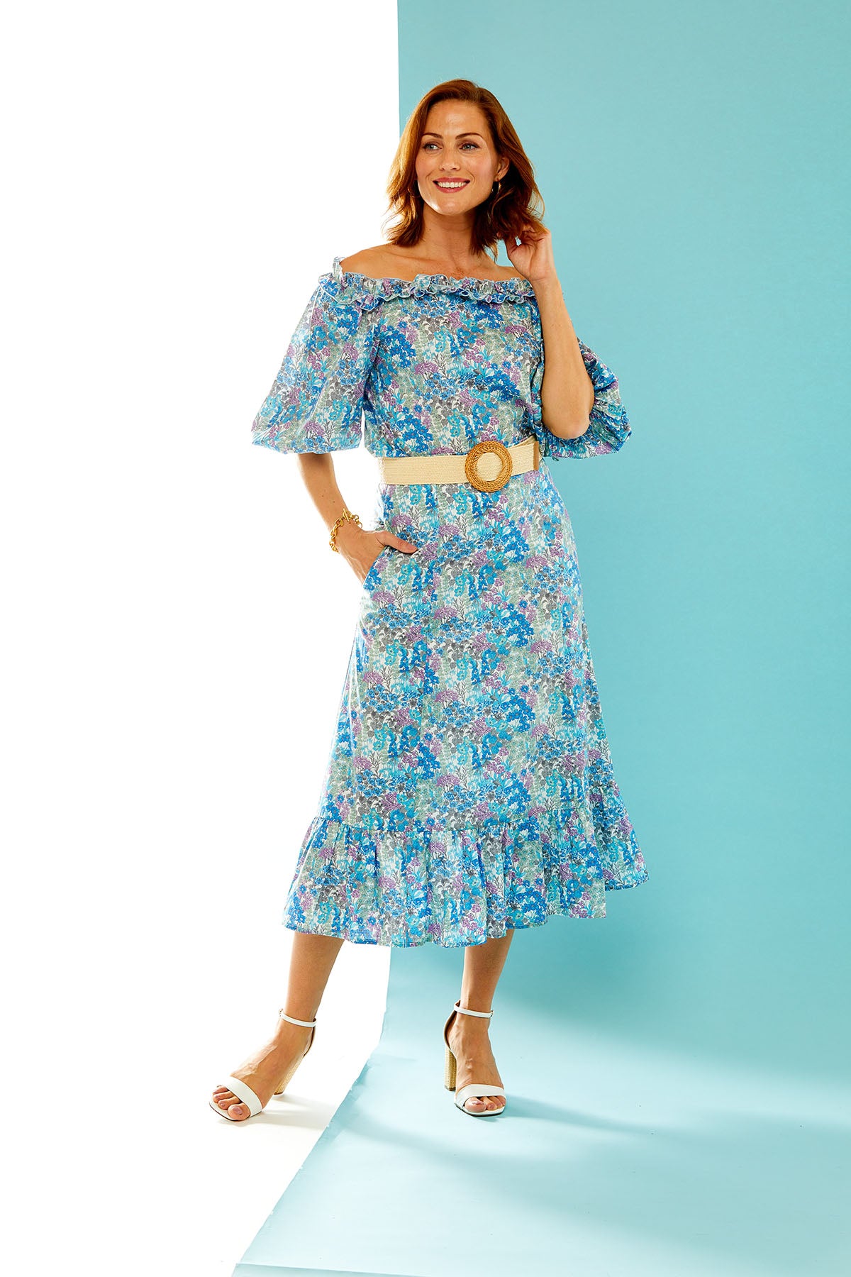 Woman in floral print blouse and skirt