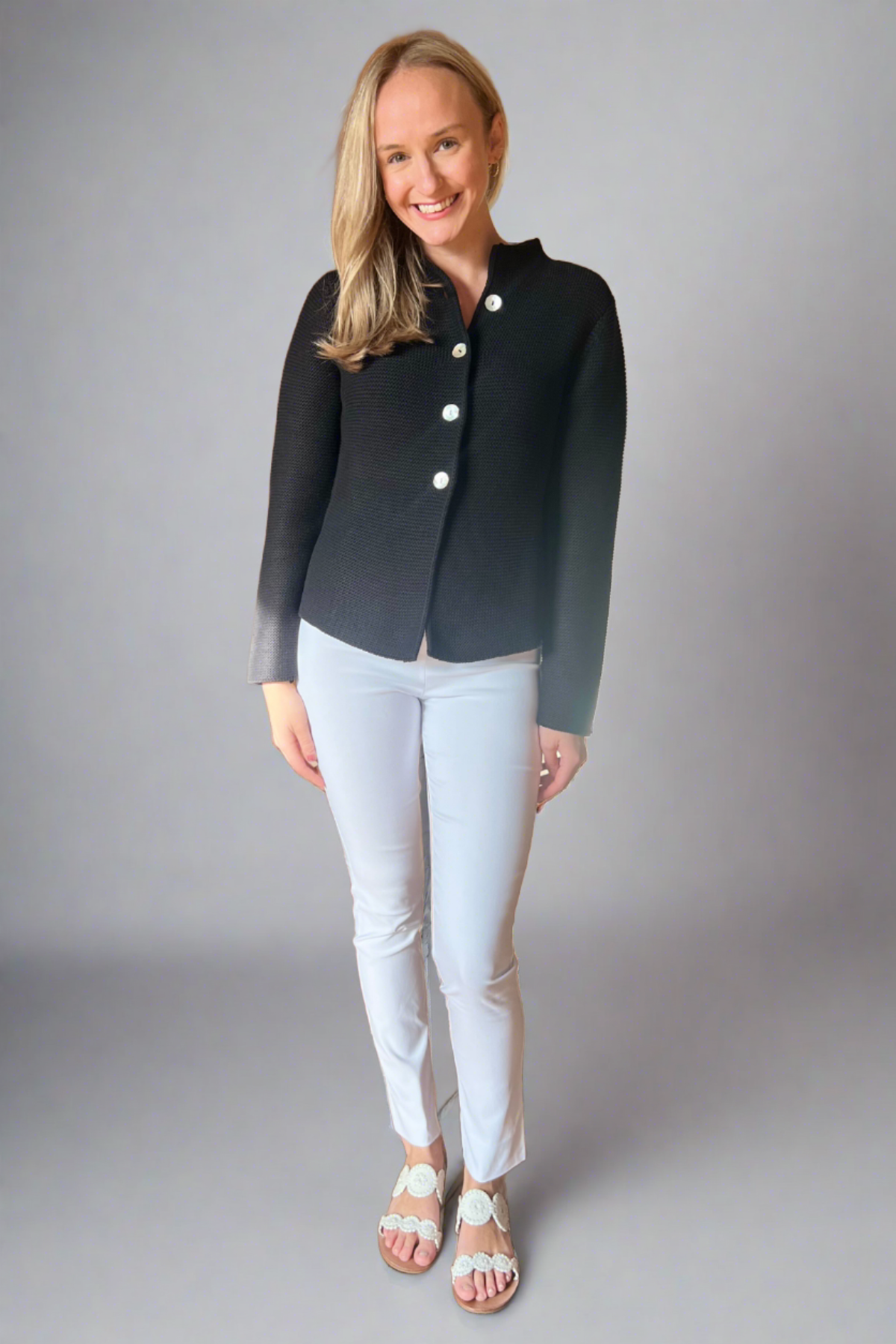 Woman in black button front nock neck cardigan
