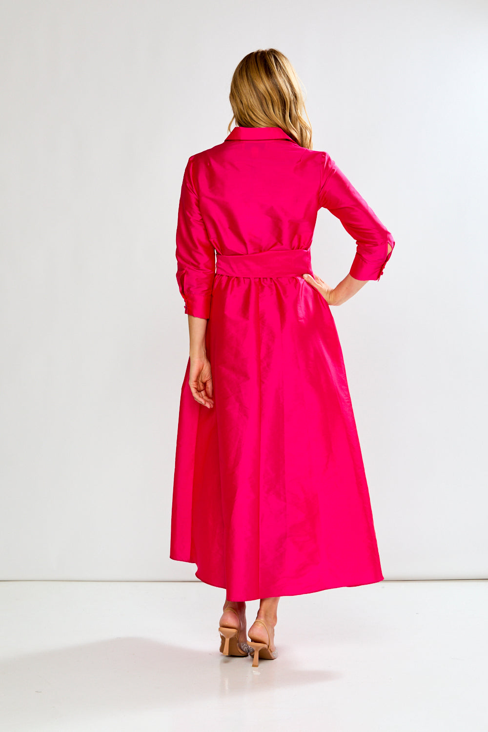 Woman wearing a Fuchsia dress on a white background