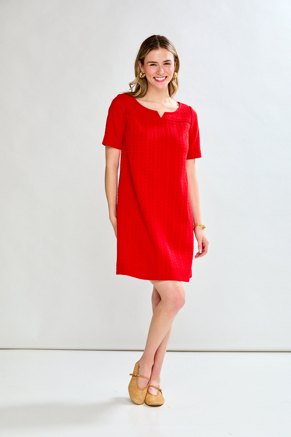 Woman wearing a red dress against a white background
