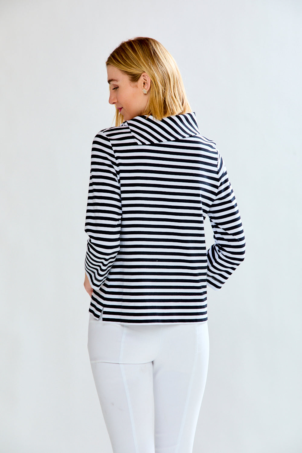 Woman in a white and black striped knit top