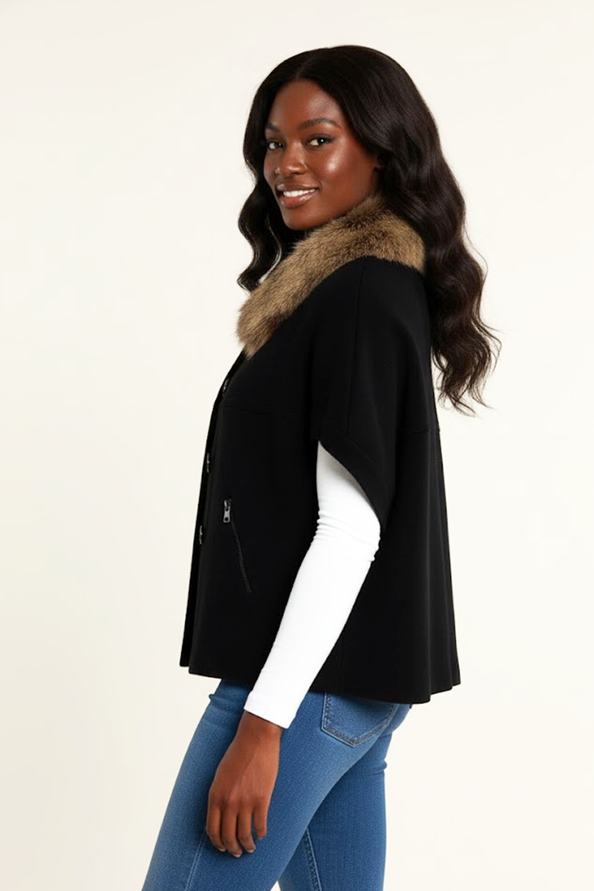 Woman wearing a black cardigan with a fur collar on a white background