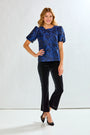 Black velvet pants worn by a person on a white background