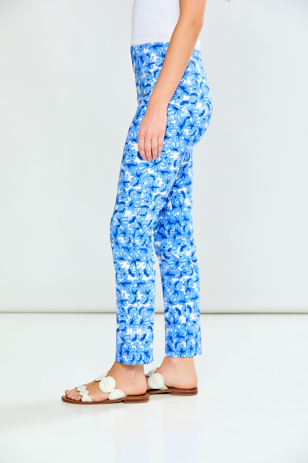 Person wearing blue floral pants on a white background