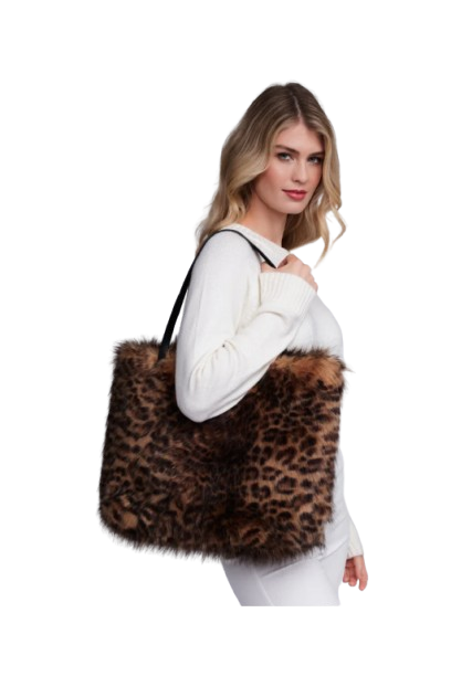 Woman holding a leopard print bag against a white background