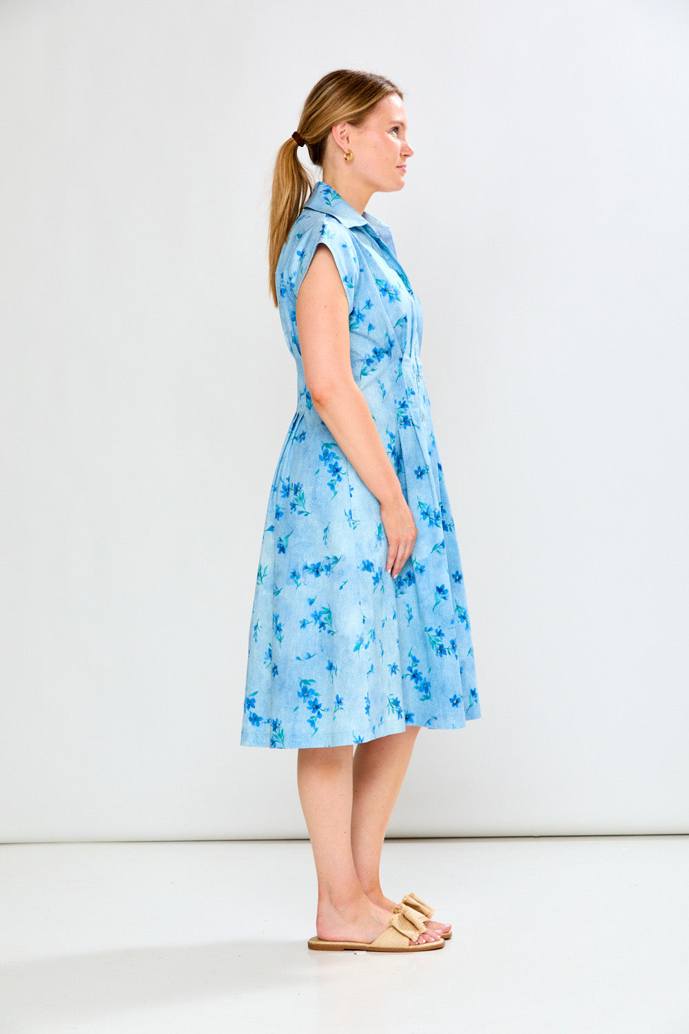 Light blue dress with floral pattern worn by a person