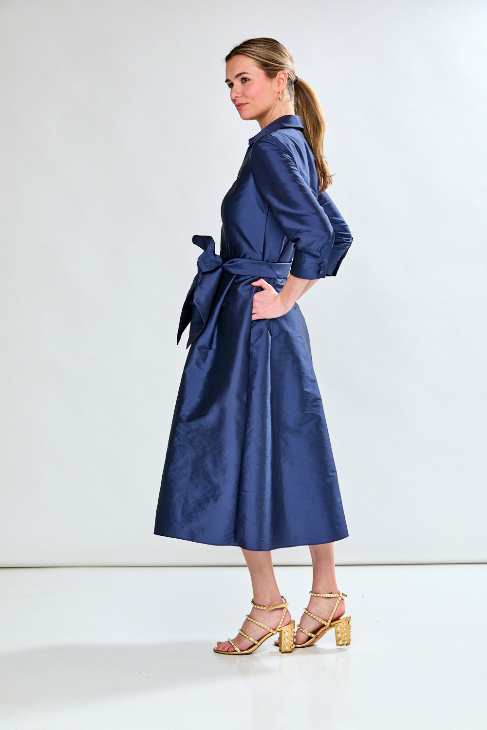 Woman in navy taffeta dress