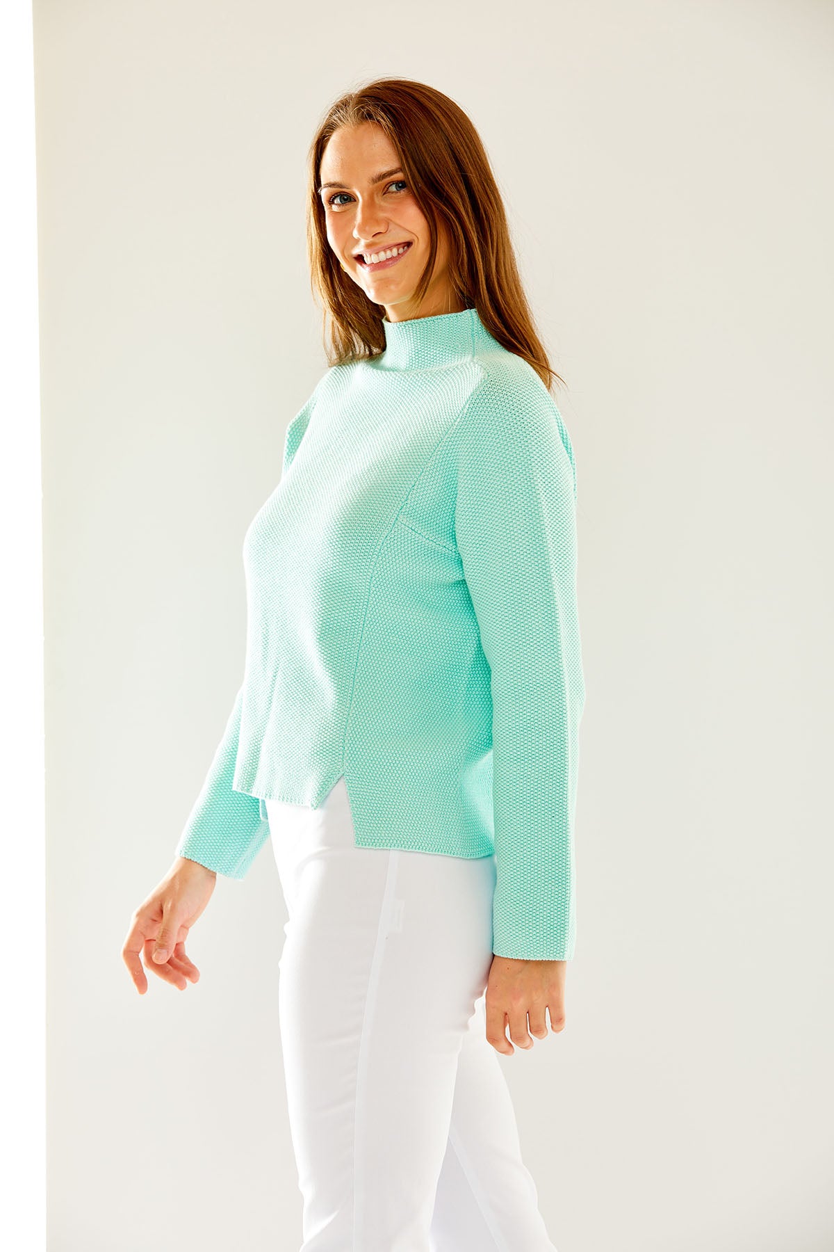 Woman wearing a turquoise sweater