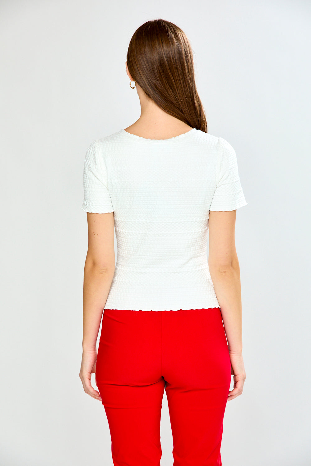 woman in white top and red pants