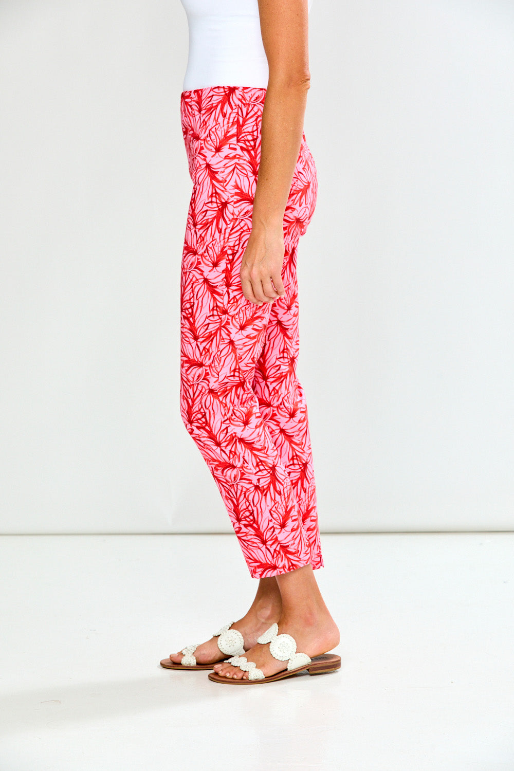 Person wearing red and white patterned pants on a white background