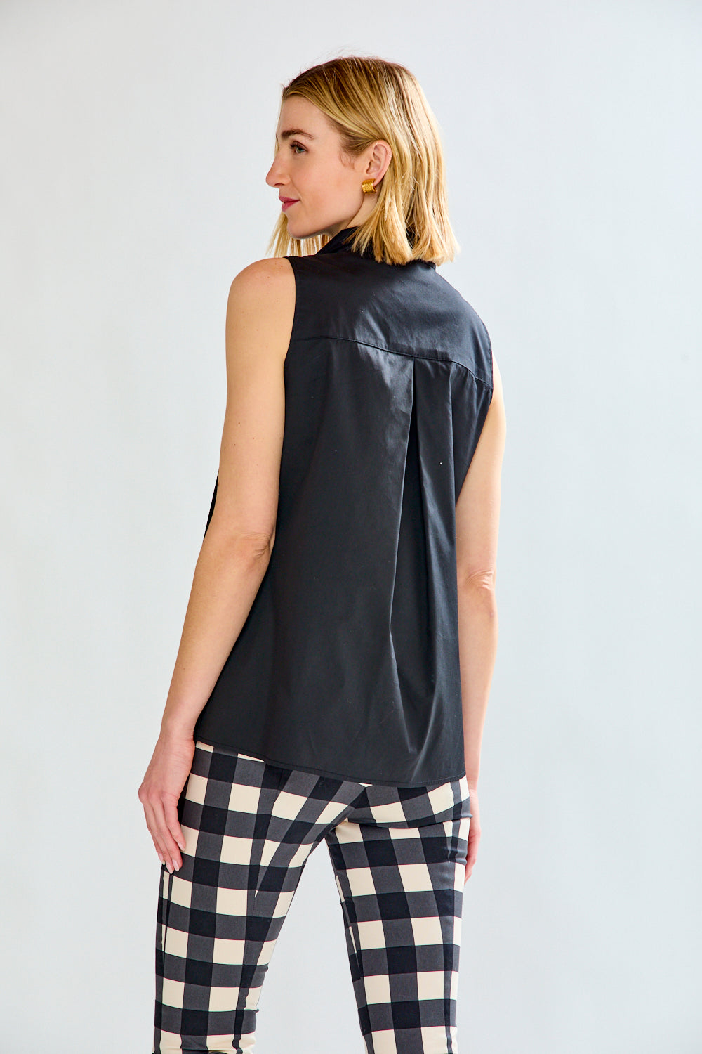 Woman in black sleeveless top