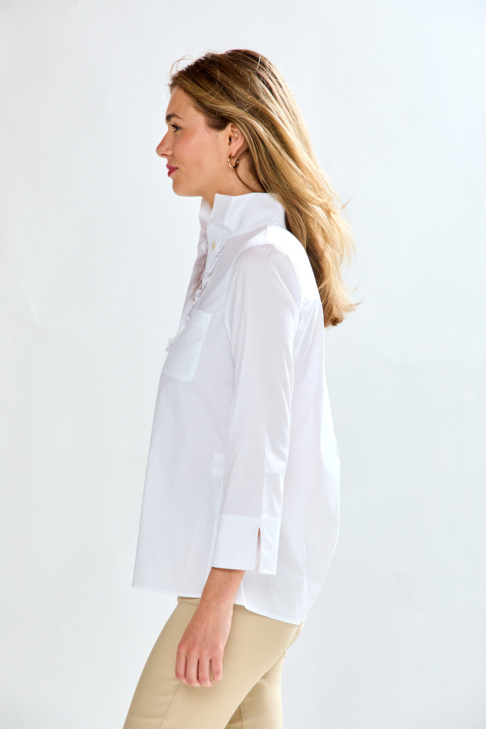 Woman in white blouse with ruffle