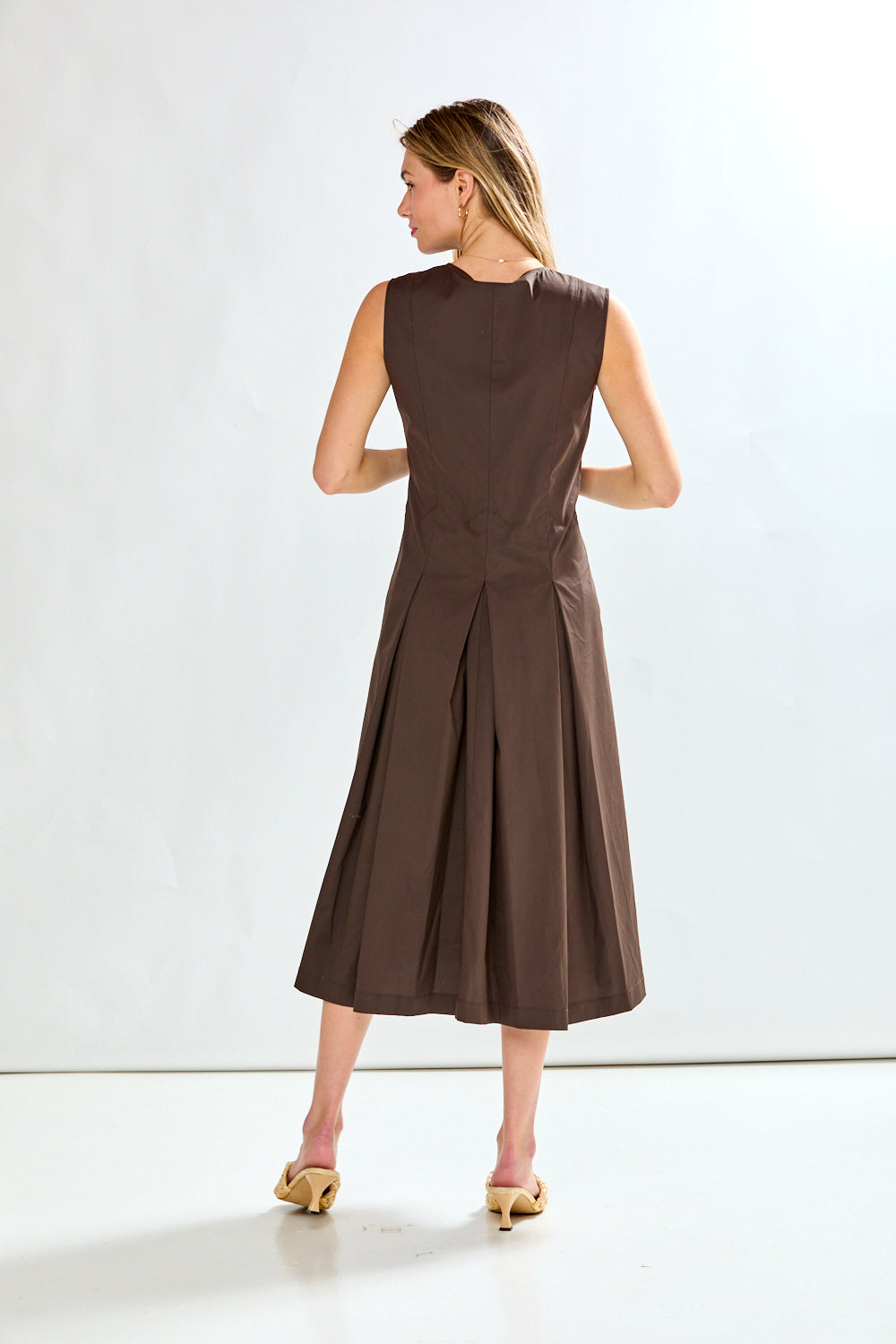 Woman wearing a brown dress on a white background