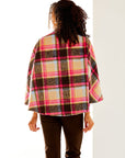 Woman in plaid cape