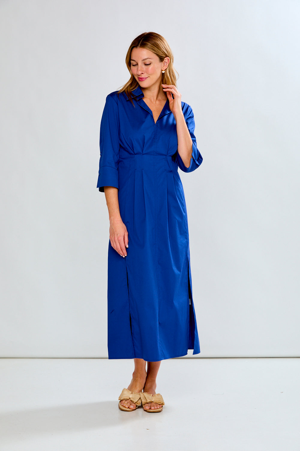 Woman wearing a blue dress against a white background