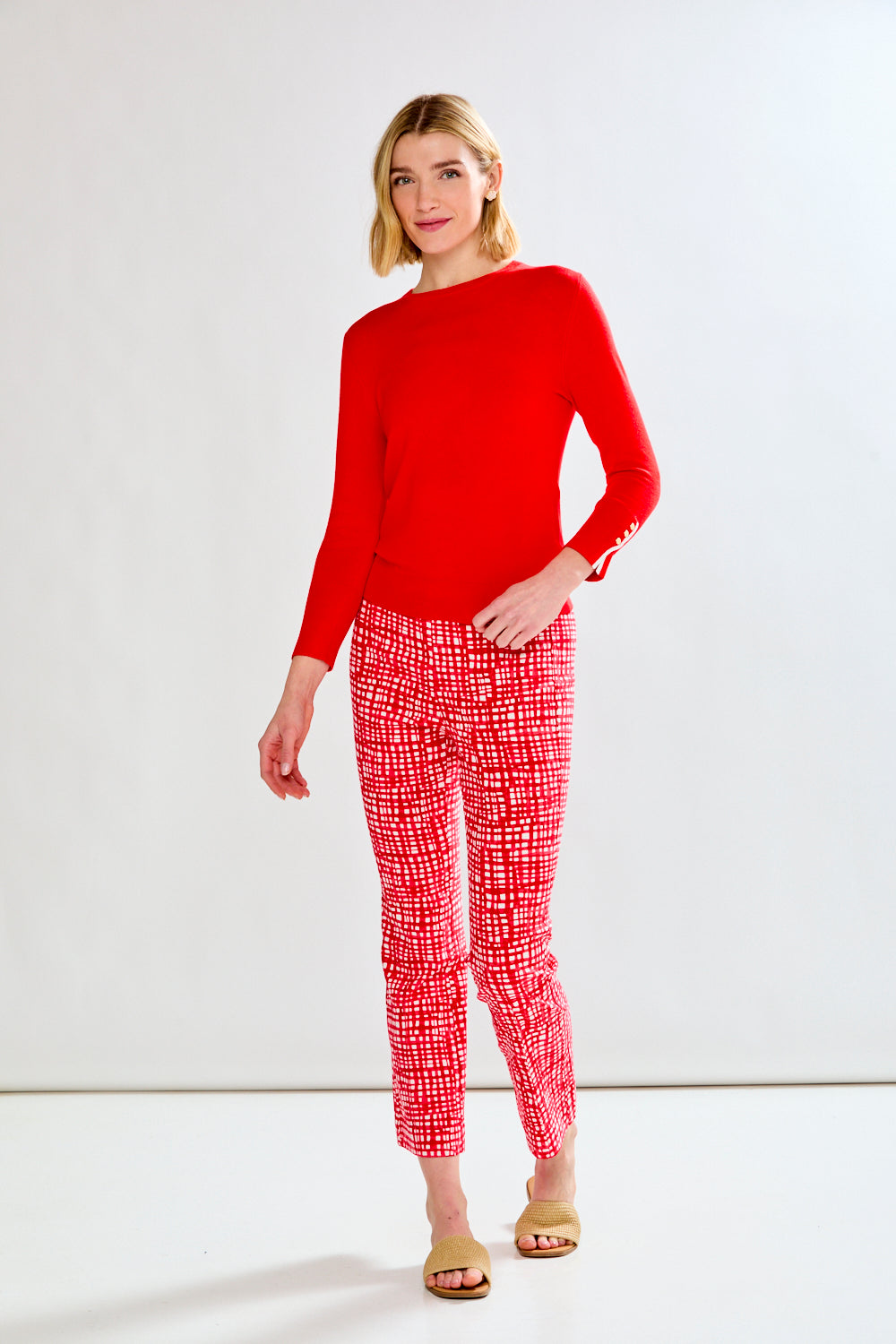 woman in red sweater and patterned pants