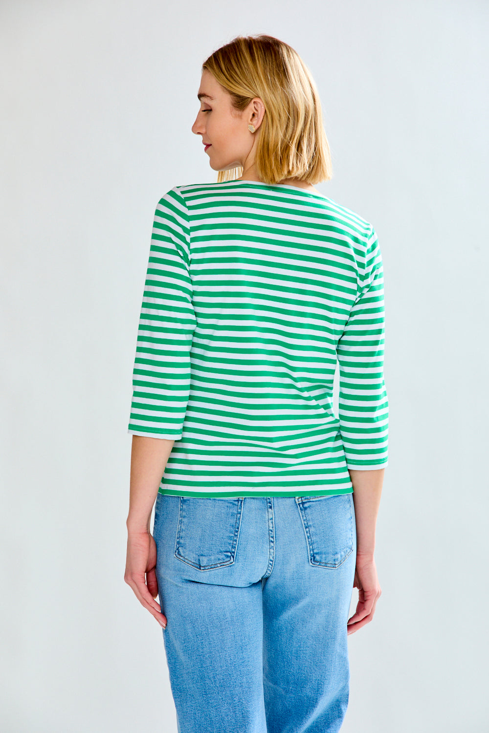 Woman in green/white stripe knit top