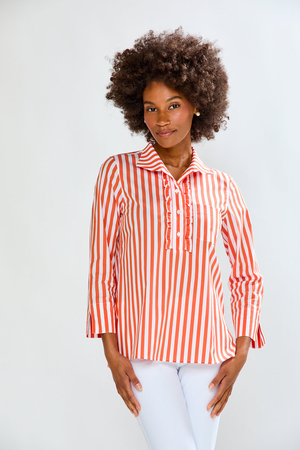 Woman wearing a red and white striped shirt against a plain background