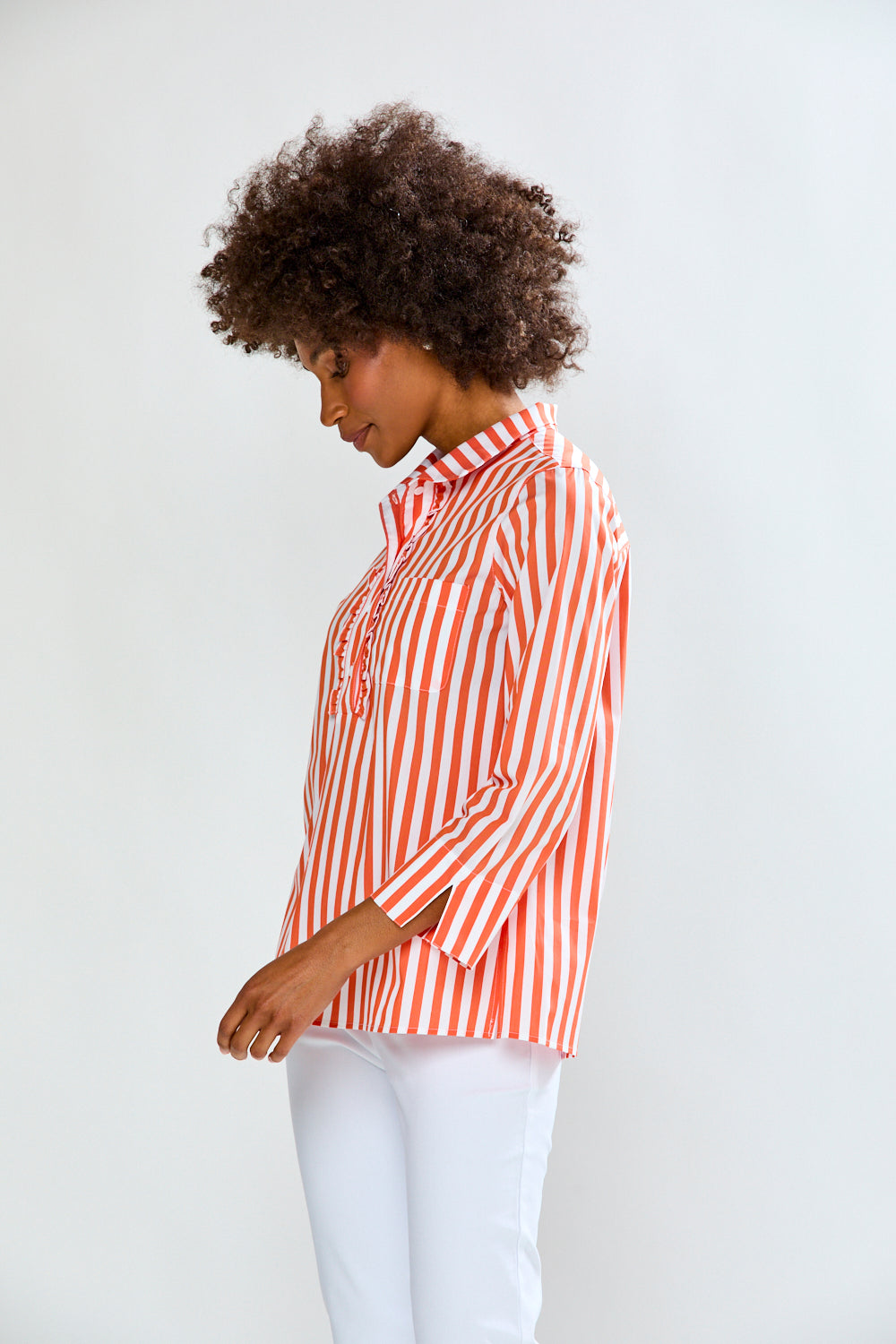Woman wearing a red and white striped shirt against a plain background