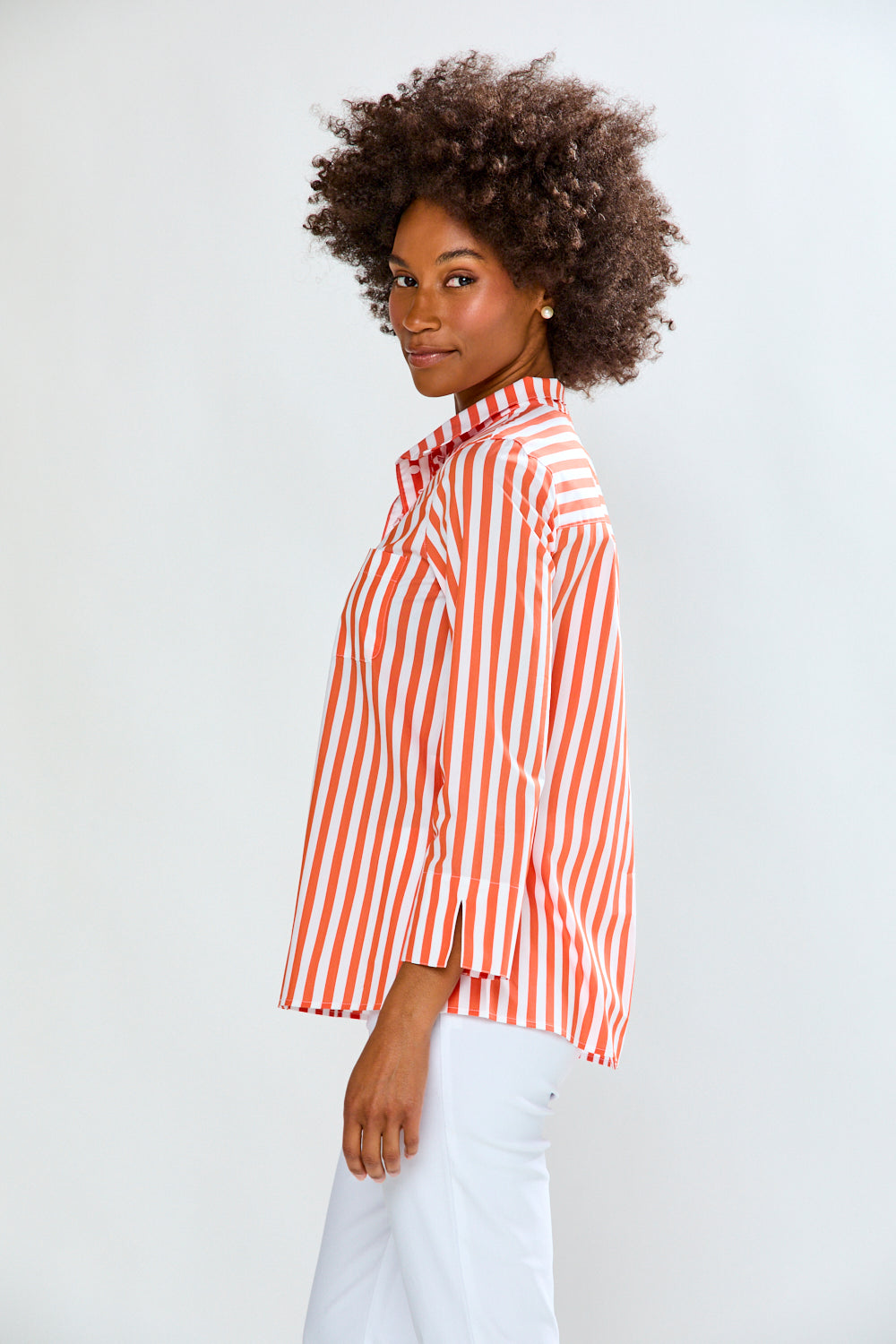 Woman wearing a red and white striped shirt against a plain background