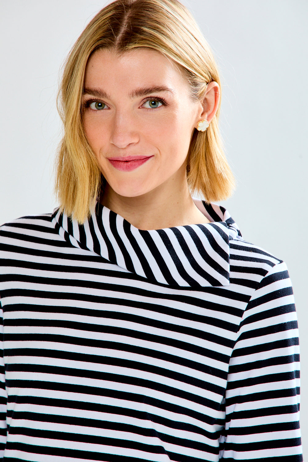 Woman in a white and black striped knit top